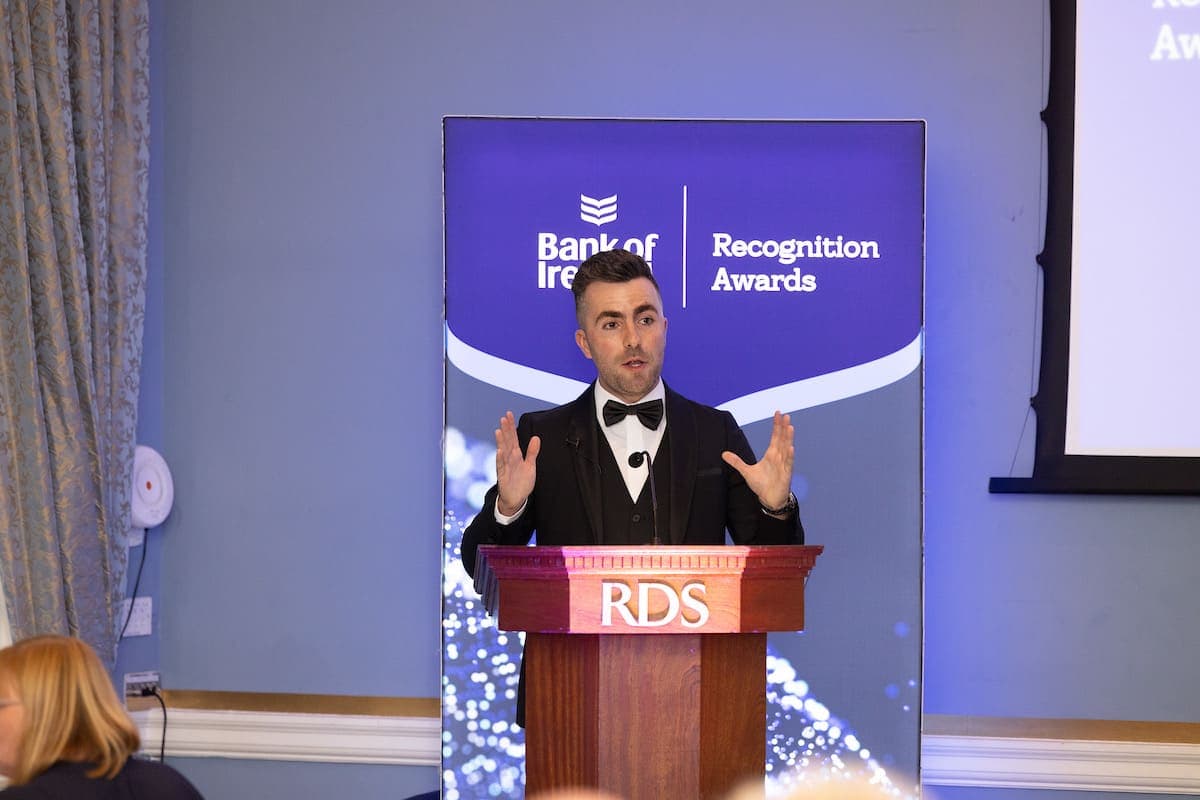 Jamie speaks from the RDS lectern in front of a Bank of Ireland Recognition Awards banner
