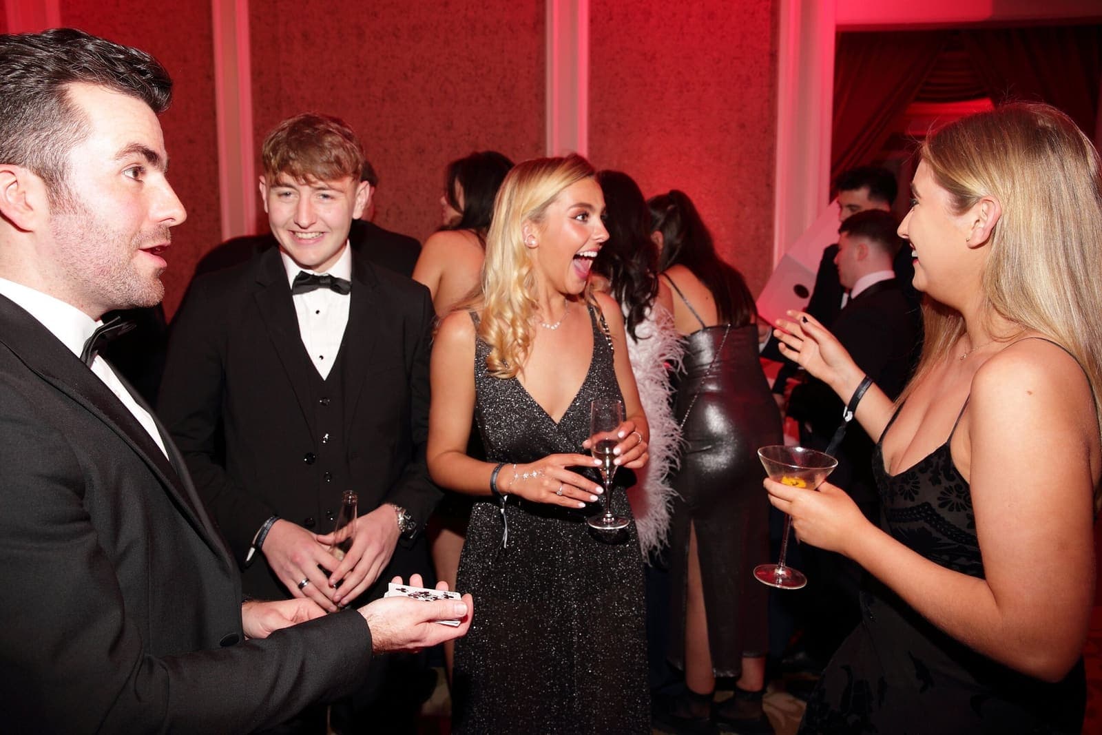 At a 21st birthday party a guest gasps, mouth wide open, as Jamie shows a card