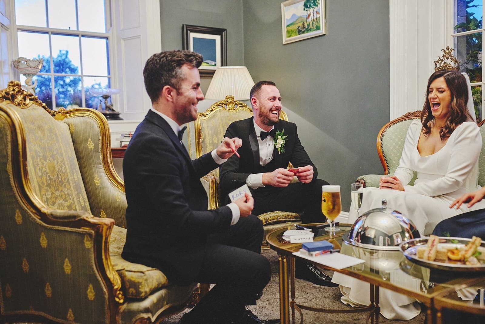 Jamie performs for a bride and groom seated in gold armchairs