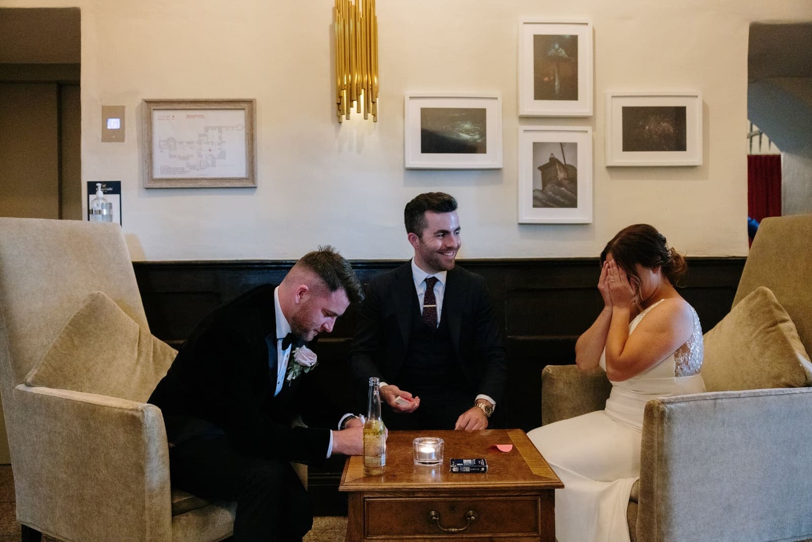 Jamie performing for a couple seated in a lounge with a small table (intimate setting)