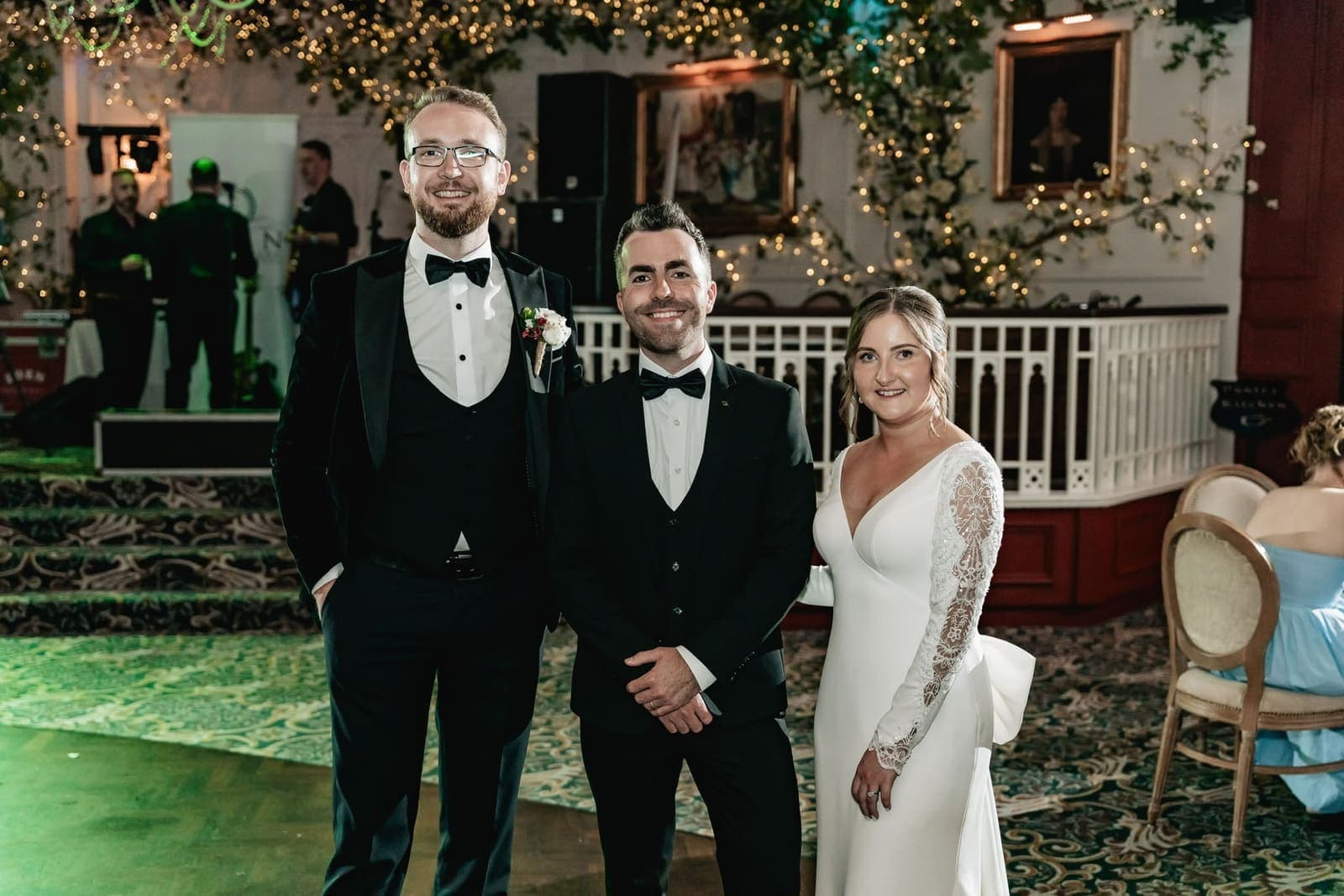 Jamie stands between Alex and Suzanne on the dance floor at Cabra Castle