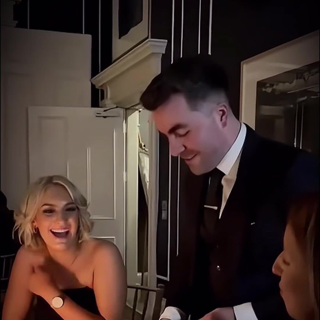 A guest laughs out loud as Jamie smiles and deals the cards at her table