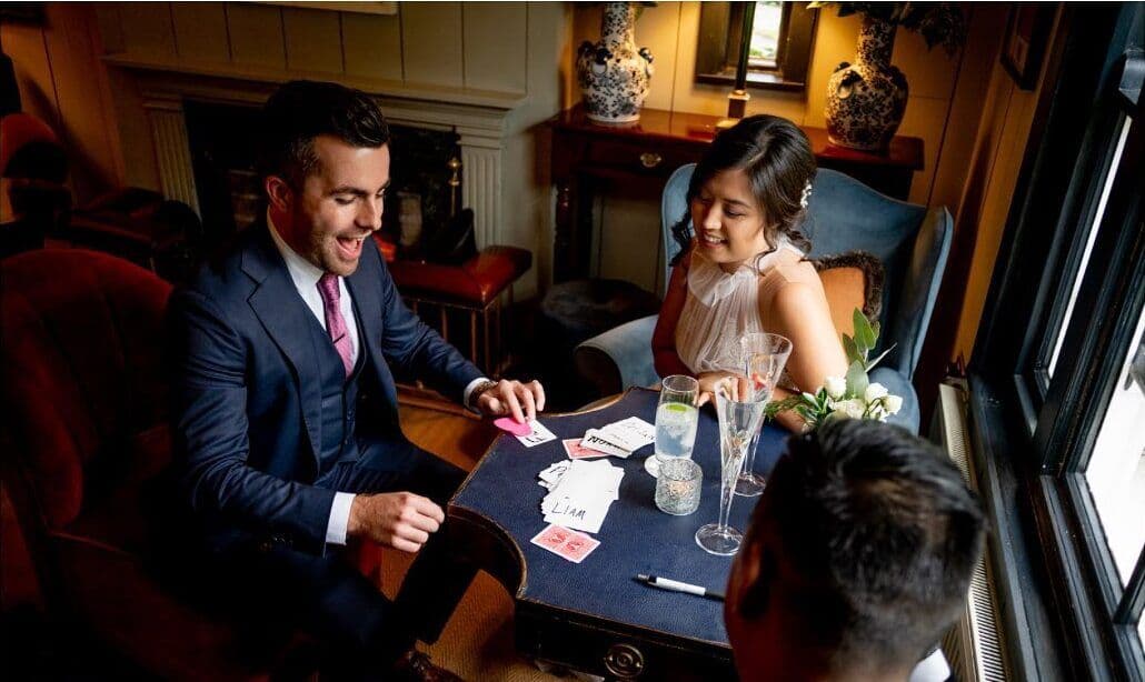Jamie laughs as he deals cards for Fiona and Michael in the library of The Station House Hotel